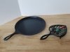 Item #137 — Lodge 10.5 inch griddle, and a cast iron trivet