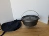 Item #35 — CAST iron cooker, stand, bag, approx 16 by 6 inch