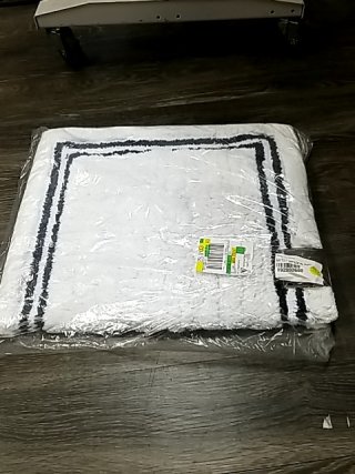 Item #17 — New White Bath Rug with Black Border 34 by 21 inch photo 1 of 2
